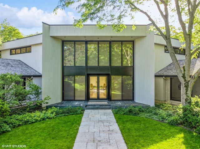 exterior space featuring french doors and a yard