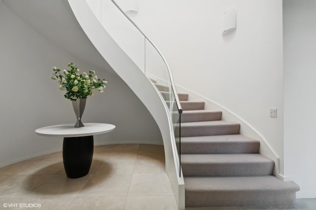 stairs featuring tile patterned flooring