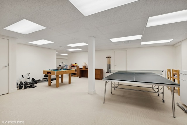 playroom with a paneled ceiling and carpet flooring