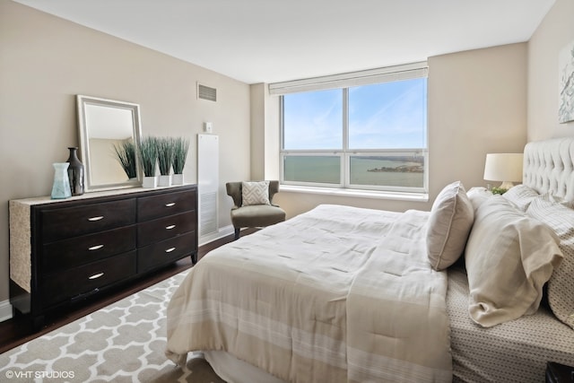 bedroom with dark wood-type flooring