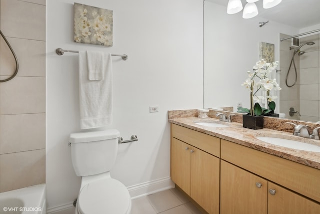 full bathroom featuring toilet, tile patterned floors, tiled shower / bath, and double vanity