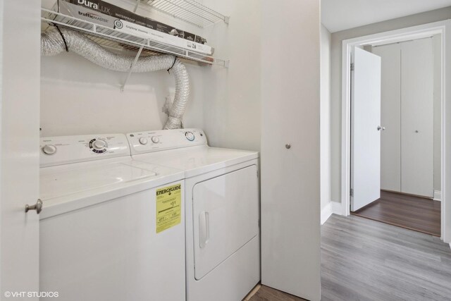 laundry area featuring washer and dryer and light wood-type flooring