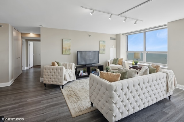 living room featuring track lighting and dark hardwood / wood-style flooring