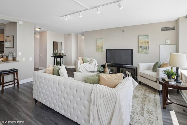 living room with hardwood / wood-style flooring and track lighting