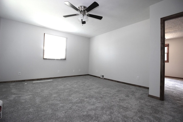 carpeted spare room with ceiling fan