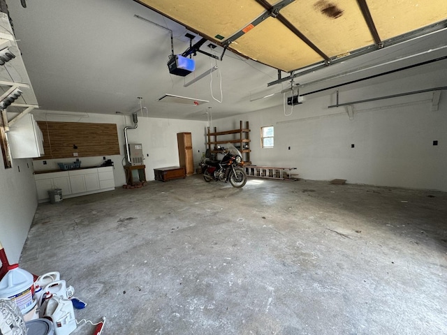 garage with a garage door opener and electric panel