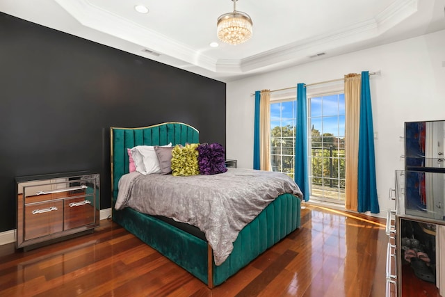 bedroom with access to outside, a raised ceiling, ornamental molding, and dark hardwood / wood-style floors