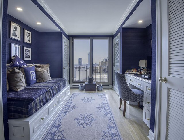 bedroom with light wood-type flooring and crown molding