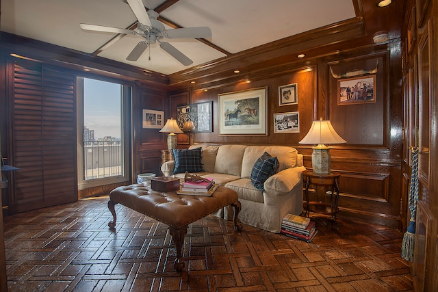 living room featuring wooden walls, ceiling fan, and dark parquet floors