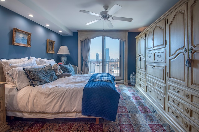 bedroom featuring access to outside, a baseboard heating unit, and ceiling fan