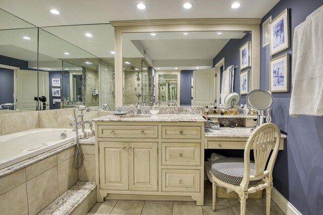 bathroom featuring tile patterned flooring, vanity, and plus walk in shower