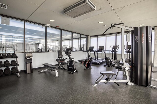 gym with a wall of windows and plenty of natural light