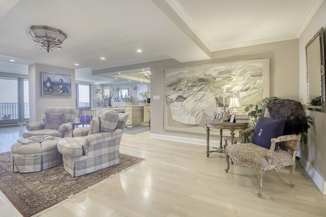 living room featuring ornamental molding and light hardwood / wood-style floors