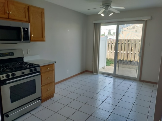 kitchen featuring ceiling fan, appliances with stainless steel finishes, and light tile patterned flooring