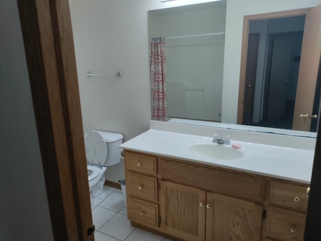 bathroom with vanity, toilet, and tile patterned floors