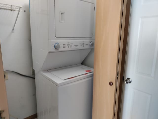 washroom featuring stacked washer and dryer