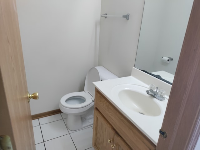 bathroom with vanity, toilet, and tile patterned floors