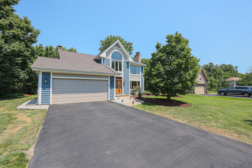 view of front facade with a garage and a front lawn