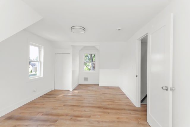 additional living space with light hardwood / wood-style floors