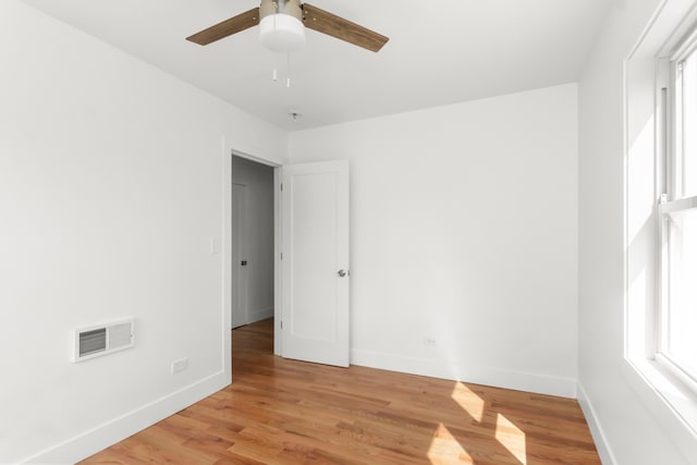 spare room featuring ceiling fan and light wood-type flooring