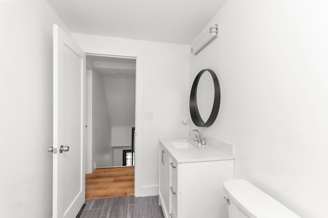 bathroom with toilet and vanity