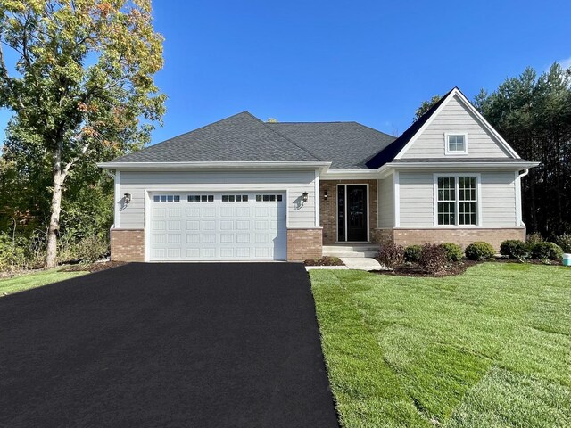 view of front of property featuring a garage and a front yard