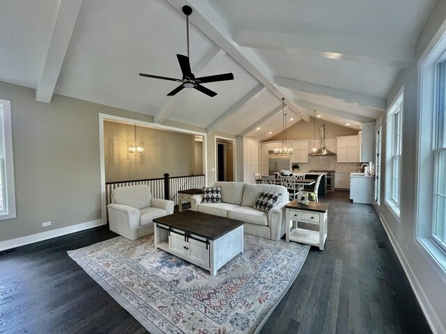 living room with lofted ceiling with beams, ceiling fan with notable chandelier, dark wood-type flooring, and sink