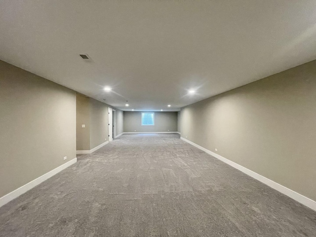 basement featuring light colored carpet