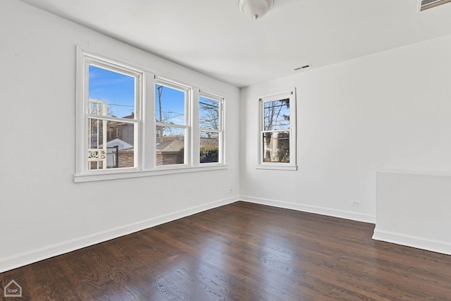 spare room with dark hardwood / wood-style flooring