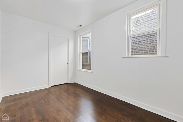 spare room featuring dark hardwood / wood-style flooring