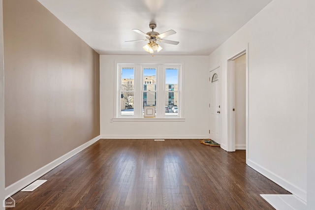 spare room featuring ceiling fan and dark hardwood / wood-style flooring