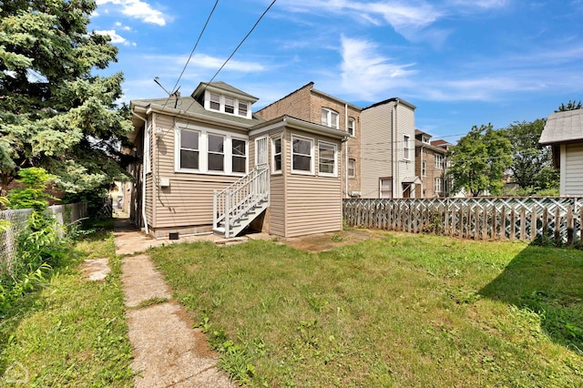 back of house with a lawn