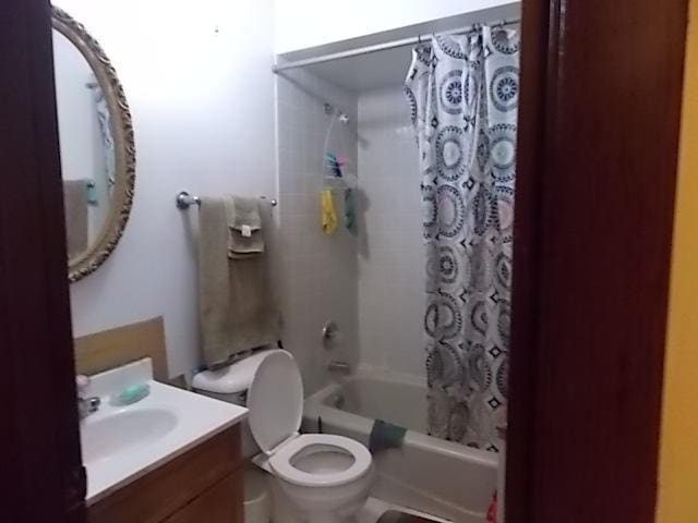 full bathroom with vanity, toilet, and shower / tub combo