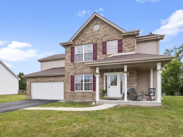 traditional home with a garage, aphalt driveway, roof with shingles, a front yard, and brick siding