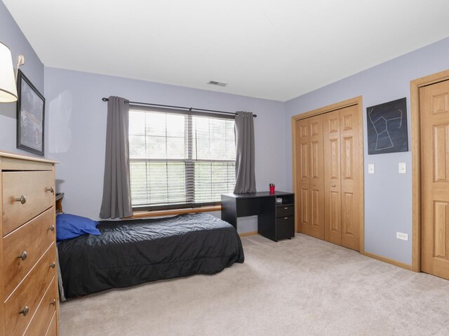 carpeted bedroom with a closet