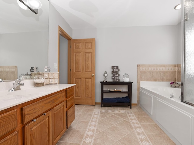 full bath with vanity, a bath, and tile patterned floors