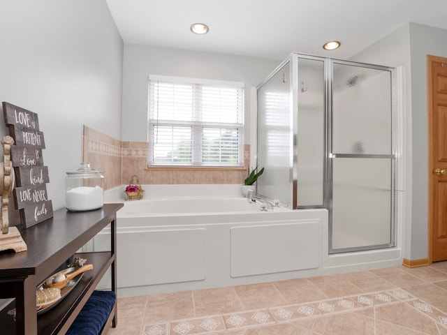 bathroom featuring tile patterned flooring and separate shower and tub