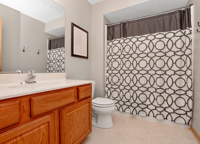 bathroom featuring toilet, vanity, and tile patterned flooring