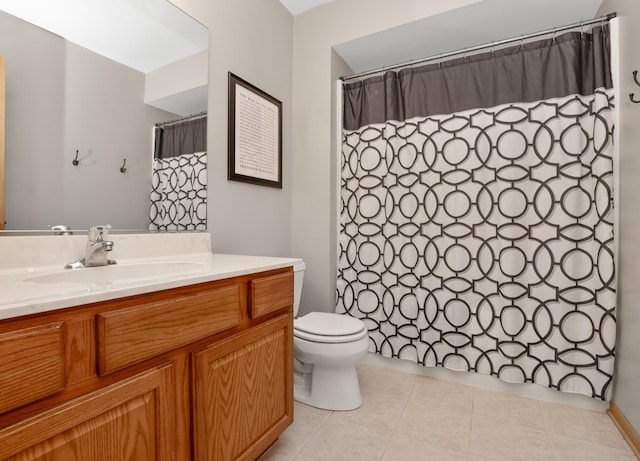 full bathroom with a shower with shower curtain, vanity, toilet, and tile patterned floors