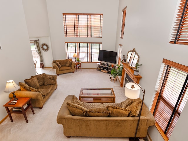 living room featuring light colored carpet and a towering ceiling