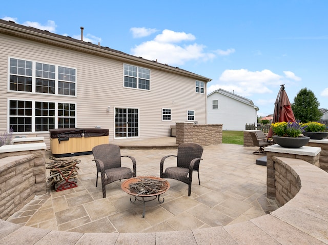 view of patio featuring a fire pit and a hot tub