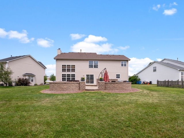 back of property with a patio and a lawn