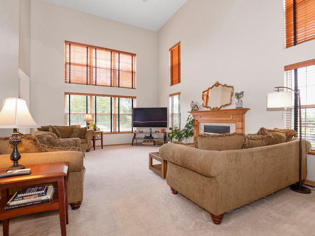 carpeted living room with a wealth of natural light and a towering ceiling