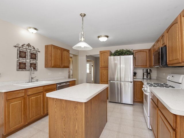 kitchen featuring light floors, appliances with stainless steel finishes, light countertops, and a sink