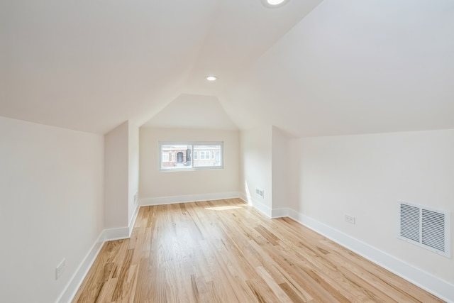 bonus room with light hardwood / wood-style flooring and lofted ceiling