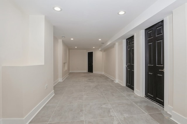 hall featuring light tile patterned floors