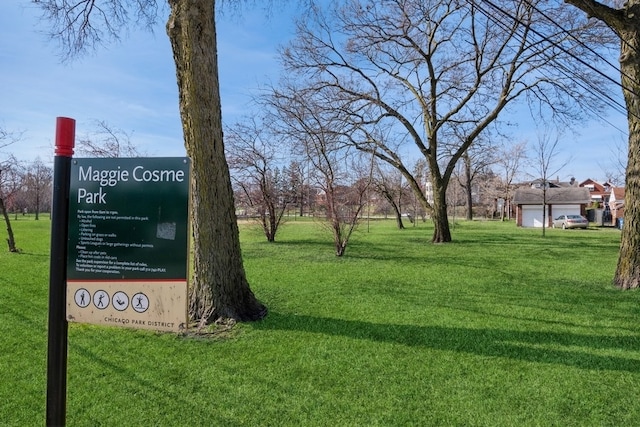 view of home's community featuring a yard and a garage