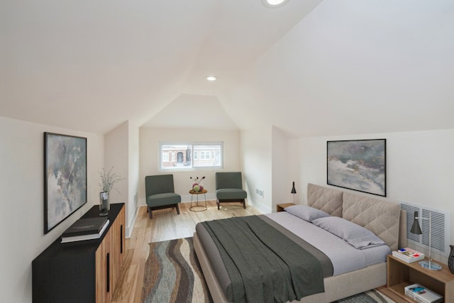 bedroom featuring lofted ceiling and light hardwood / wood-style floors