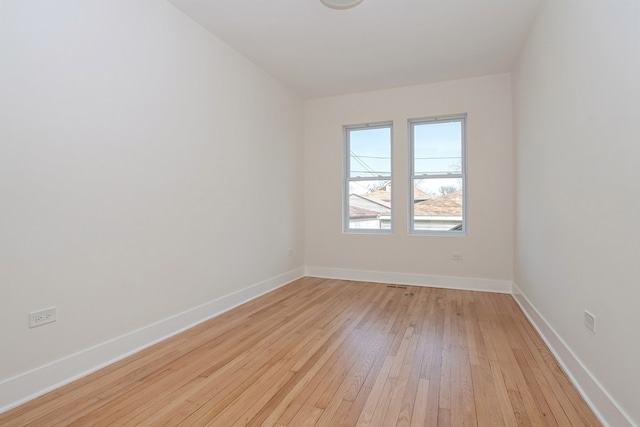 spare room featuring light wood-type flooring