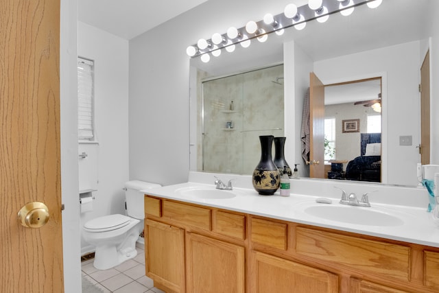 bathroom with vanity, ceiling fan, an enclosed shower, toilet, and tile patterned floors